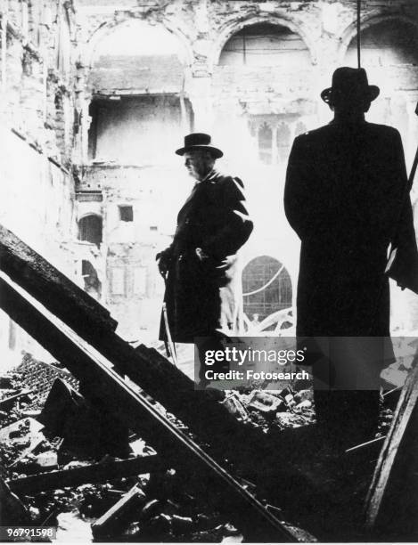 Prime Minister Winston Churchill inspecting the damage inflicted by incendiaries to the Debating Chamber of the House of Commons, circa 1940s. .