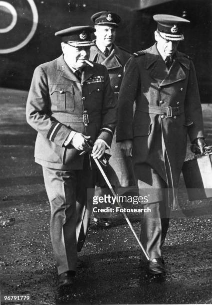 Prime Minister Winston Churchill on his return from the middle east, walking with Air Chief Marshal Sir Charles Portal, circa 1943. .