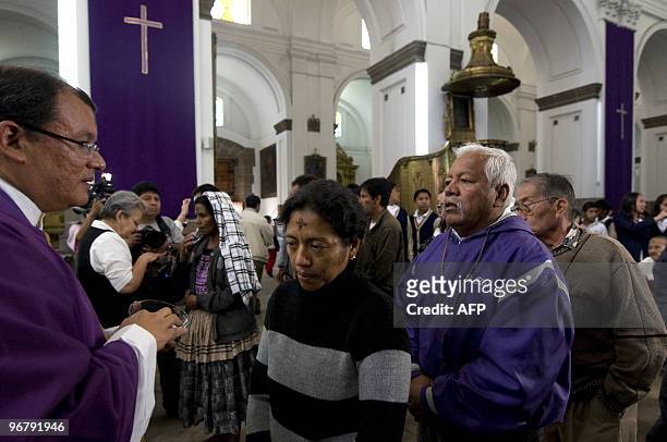 Catholic parishioners participate in the traditional Ash Wednesday ceremony at the Metropolitan Cathedral in downtown Guatemala City February 17,...