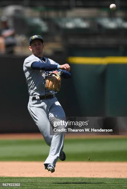 Daniel Robertson of the Tampa Bay Rays throws off balance to first base thowing out Bruce Maxwell of the Oakland Athletics in the bottom of the six...