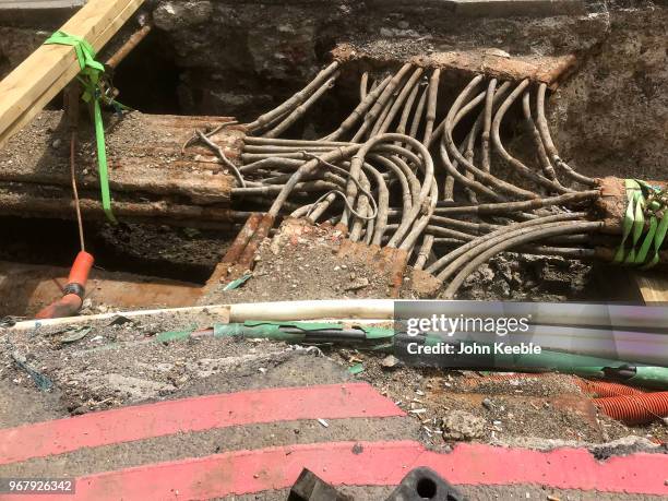 Underground cables and pipes are exposed in a hole during roadworks at the junction of King William Street, Eastcheap and London Bridge on June 2,...