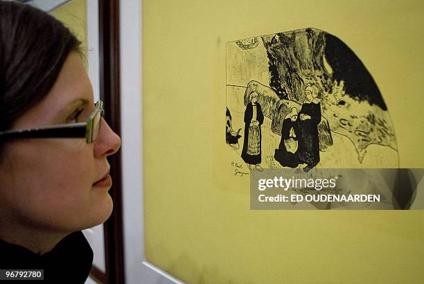 Visitor watches a lithography of the Volpini-serie on February 17, 2010 in Amsterdam. The Van Gogh Museum in Amsterdam shows works of French paintor...