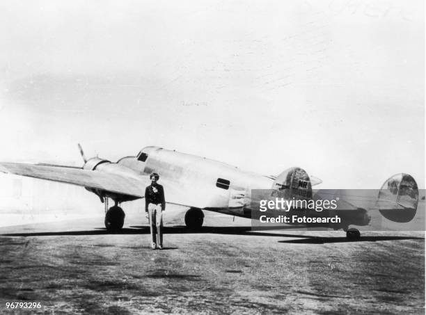 Amelia Earhart in front of her new plane Electra, circa 1937. .