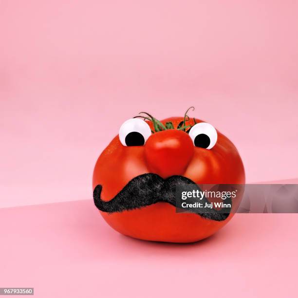 tomato with eyes and mustache - big mustache stock-fotos und bilder