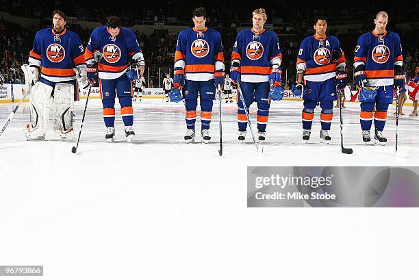 The starting lineup of Dwayne Roloson, Mark Streit, Bruno Gervais, Sean Bergenheim, Richard Park and Blake Comeau of the New York Islanders stand...