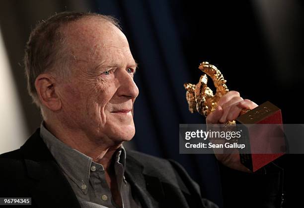 Screenwriter Wolfgang Kohlhaase holds up his Honorary Golden Bear after receiving the award at Kino International during the 60th Berlinale...