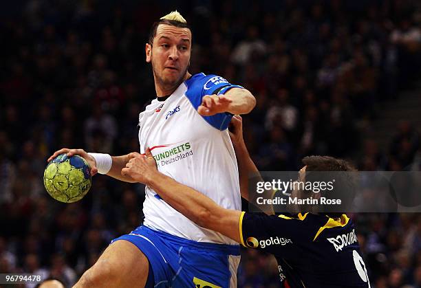 Pascal Hens of Hamburg in action with Nikola Manojlovic of Rhein Neckar Loewen during the Bundesliga match between HSV Hamburg and Rhein Neckar...