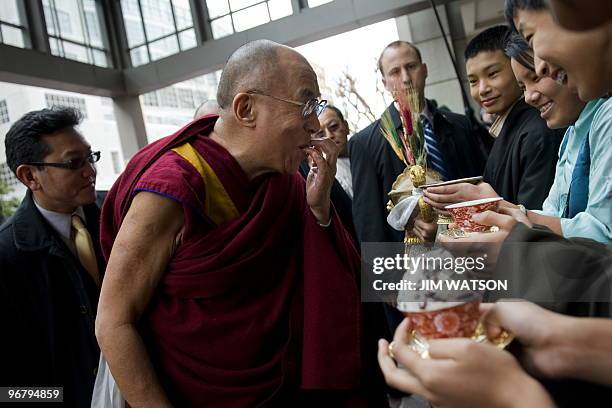 Exiled Tibetan spiritual leader the Dalai Lama participates in a Tibetan New Year celebration as he arrives at the Park Hyatt hotel in Washington,...