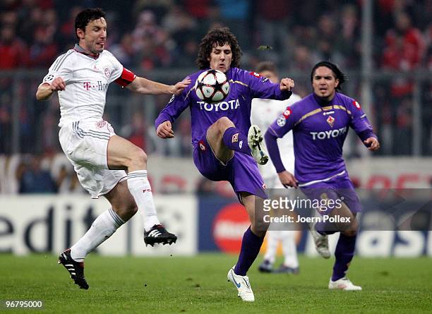 Mark van Bommel of Bayern, Stevan Jovetic and Juan Vargas of Florence jump for a header during the UEFA Champions League round of sixteen, first leg...