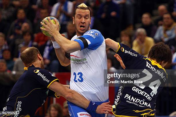 Pascal Hens of Hamburg in action with Olafur Stefansson and Patrick Groetzke of Rhein Neckar Loewen during the Bundesliga match between HSV Hamburg...