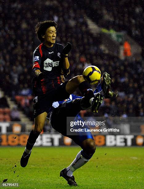 Titus Bramble of Wigan battles with Chung-Yong-Lee of Bolton during the Barclays Premier League Match between Wigan Athletic and Bolton Wanderers at...