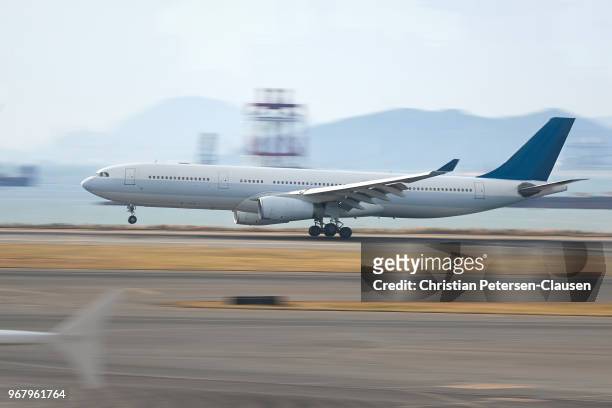 passenger aircraft landing on airport runway - airplane runway stockfoto's en -beelden