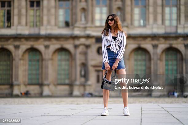 Amanda Derhy wears a Misguided striped top, a Primark blue denim skirt, a Coach silver bag, Adidas Stan Smith white sneakers shoes, on May 27, 2018...