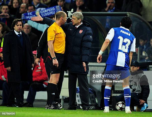Arsenal manager Arsene Wenger argues with referee Martin Hansson after Porto score their second goal during the UEFA Champions League last 16 first...