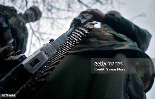 Indian soldiers stand guard after a gun battle on February 17, 2010 in Kachwa Maqam, 60 km north of Srinagar, Kashmir, India. Two separatist...