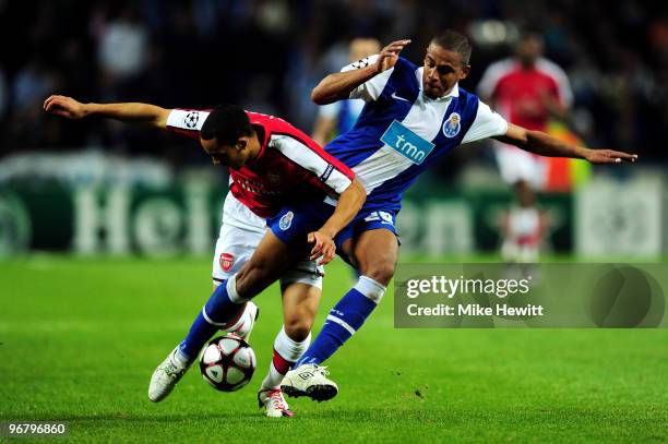 Fernando of FC Porto and Theo Walcott of Arsenal battle for the ball during the UEFA Champions League last 16 first leg match between FC Porto and...