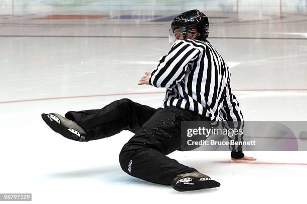 Linesman falls in the second period because he left his skate guards on during the ice hockey men's preliminary game between Finland and Belarus on...