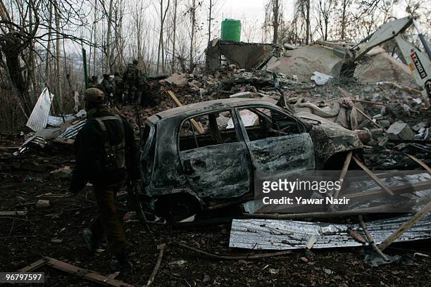 Indian soldiers search debris of a residential house, destroyed by them after a gun battle on February 17, 2010 in Kachwa Maqam, 60 km north of...