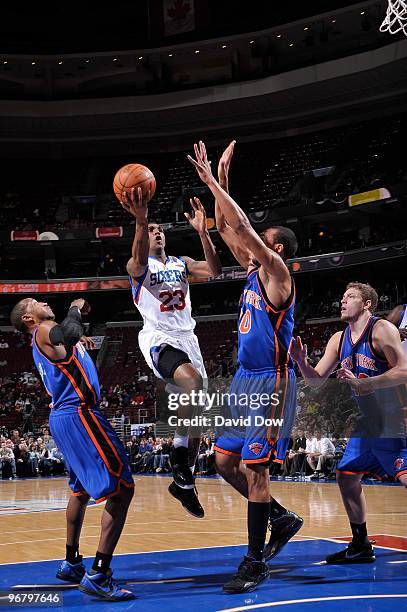 Lou Williams of the Philadelphia 76ers takes the ball to the basket against Chris Duhon and Jared Jeffries of the New York Knicks during the game on...