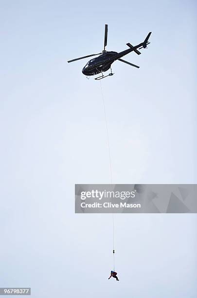 Helicopter arrives to pick up Edith Miklos of Romania, who crashed during the Alpine Skiing Ladies Downhill on day 6 of the Vancouver 2010 Winter...