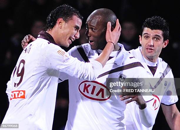 Bordeaux' forward Marouane Chamakh is congratulated by teammates after scoring a goal during the French League cup football match Lorient vs....