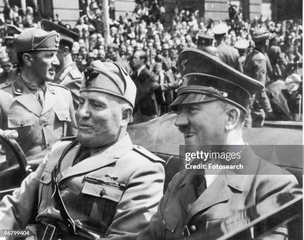 Adolf Hitler and Benito Mussolini riding in an open car, circa 1940s. .