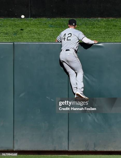Adam Engel of the Chicago White Sox looks on as a three-run home run by Eduardo Escobar of the Minnesota Twins clears the center field fence during...