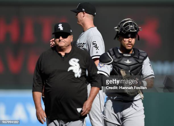 Nate Jones of the Chicago White Sox looks on after a mound visit by assistant pitching coach Don Cooper and Omar Narvaez during the eighth inning of...