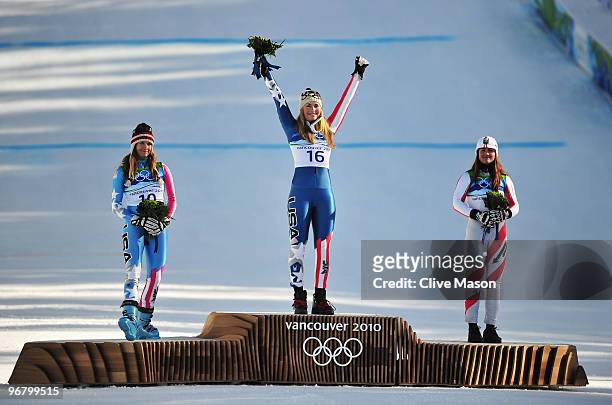 Julia Mancuso of the United States celebrates winning silver, Lindsey Vonn of the United States gold and Elisabeth Goergl of Austria bronze during...