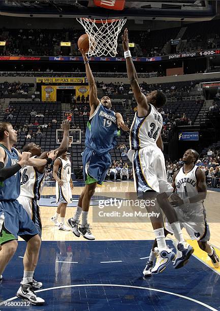 Wayne Ellington of the Minnesota Timberwolves shoots a layup against Hasheem Thabeet of the Memphis Grizzlies during the game at the FedExForum on...