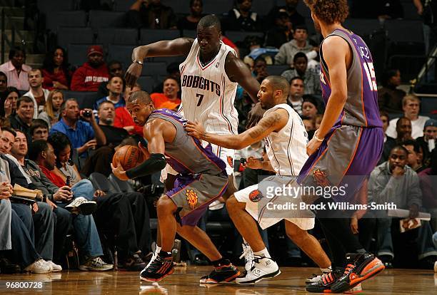 Leandro Barbosa of the Phoenix Suns moves the ball against DeSagana Diop and Acie Law of the Charlotte Bobcats during the game on January 16, 2010 at...
