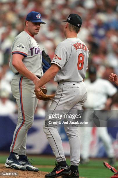 Roger Clemens of the Toronto Blue Jays meets with Cal Ripken Jr. Of the Baltimore Orioles during the 69th MLB All-Star Game at Coors Field on July 7,...