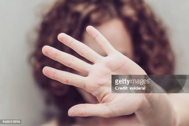 woman makes stop gestures - woman violence stock-fotos und bilder