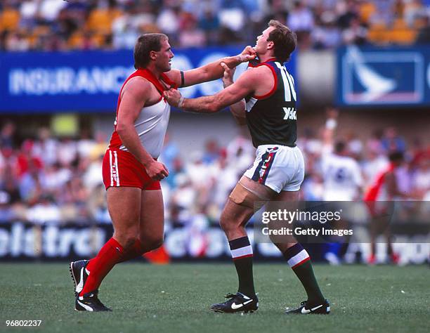 Tony Lockett of the Swans fights with a Fremantle Dockers defender during an AFL match at the SCG in Sydney, Australia.