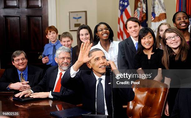 President Barack Obama, flanked by Congressional leaders and middle school students from Michigan, Florida and Nebraska, congratulates the astronauts...