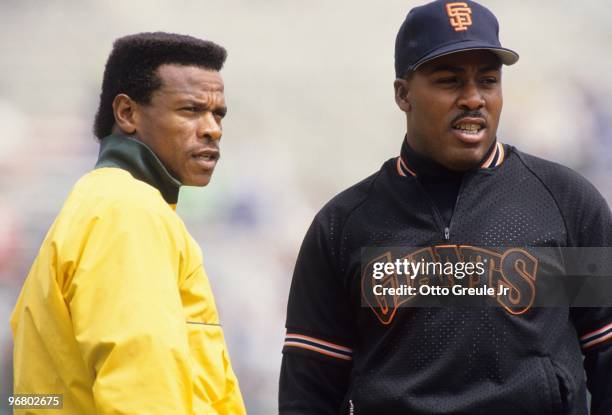 S: Rickey Henderson of the Oakland Athletics and Kevin Mitchell of the San Francisco Giants look on during batting practice prior to an MLB game at...