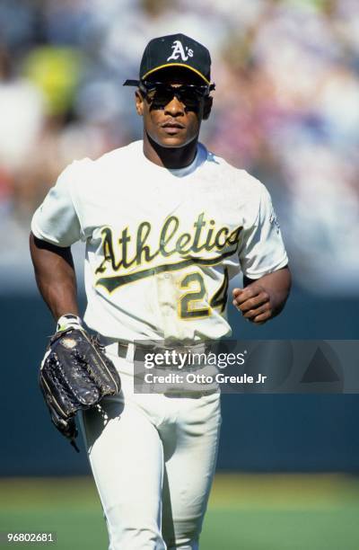 Rickey Henderson of the Oakland Athletics looks on during an MLB game at Oakland-Alameda Coliseum circa 1990 in Oakland, California.