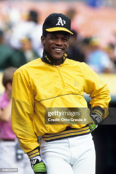 Rickey Henderson of the Oakland Athletics smiles during batting practice prior to an MLB game at Oakland-Alameda Coliseum circa 1990 in Oakland,...