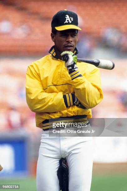 Rickey Henderson of the Oakland Athletics looks on during batting practice prior to an MLB game at Oakland-Alameda Coliseum circa 1990 in Oakland,...
