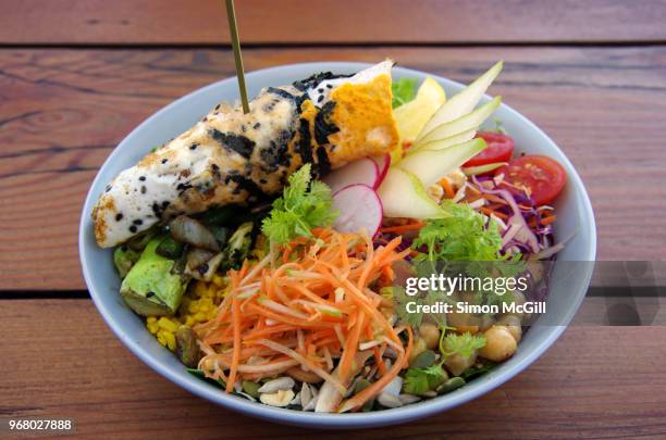 buddha bowl with salad, pear, cherry tomato, red cabbage, broccoli, charred greens, chickpeas, grated carrot, sprouts, rice, grains, nuts, seeds & lemon hummus topped with a seaweed & black sesame omelette - red seaweed stock pictures, royalty-free photos & images