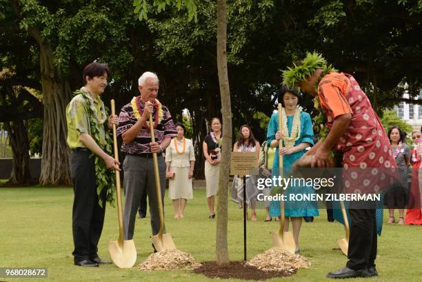 Prince Akishino of Japan, Honolulu Mayor Kirk Caldwell and Princess Kiko of Japan plant a tree at Thomas Square Park in Honolulu, Hawaii, on June 5...