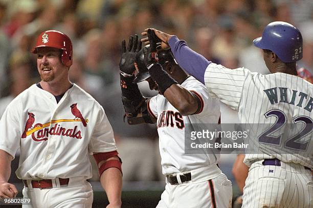 Mark McGwire of the St. Louis Cardinals, Barry Bonds of the San Francisco Giants and Devon White of the Arizona Diamondbacks celebrate during the...