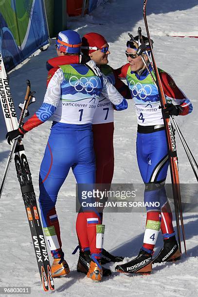 Russia's Nikita Kriukov and compatriot Alexander Panzhinskiy talk with Slovenia's Katja Visnar after competing in the men's Nordic Cross Country...