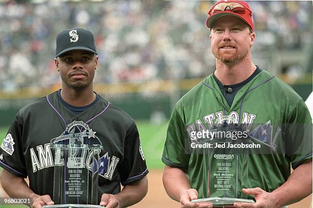 Ken Griffey Jr. And Mark McGwire display trophies for getting the most votes in all-star balloting prior to the 69th MLB All-Star Game at Coors Field...