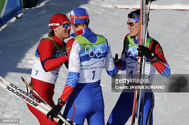 Russia's Nikita Kriukov and compatriot Alexander Panzhinskiy talk with Slovenia's Katja Visnar after competing in the men's Nordic Cross Country...