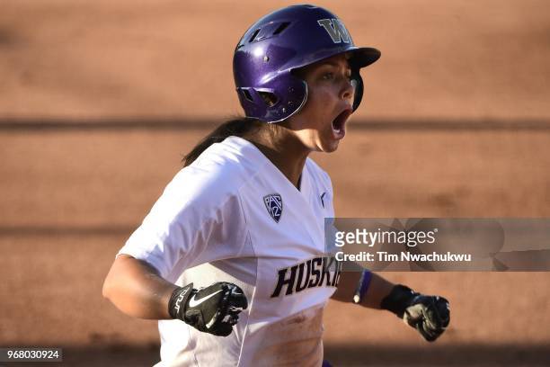 Julia DePonte of the Washington Huskies celebrates as she is scoring against the Florida State Seminoles during the Division I Women's Softball...