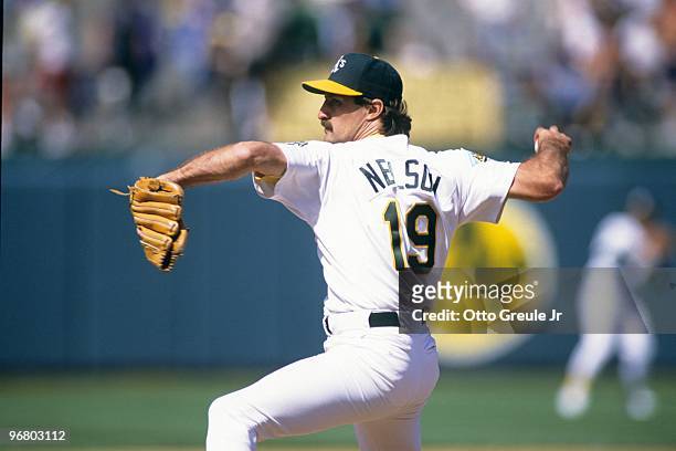 Gene Nelson of the Oakland Athletics pitches during a game against the California Angels at Oakland-Alameda County Coliseum on April 22, 1992 in...