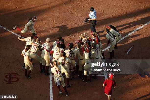 Anna Shelnutt of the Florida State Seminoles hits a home run against the Washington Huskies during the Division I Women's Softball Championship held...