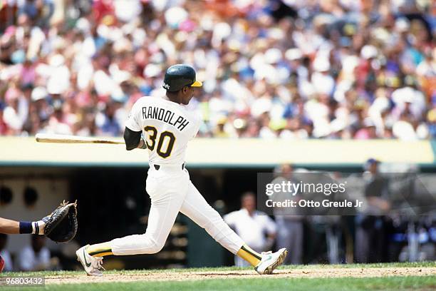 Willie Randolph of the Oakland Athletics makes a hit during a 1990 season game at Oakland-Alameda County Coliseum in Oakland, California.