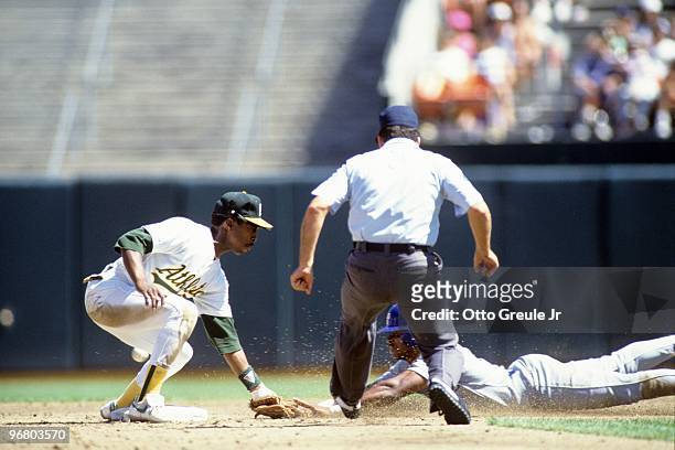 Willie Randolph of the Oakland Athletics makes a tag during a 1990 season game at Oakland-Alameda County Coliseum in Oakland, California.